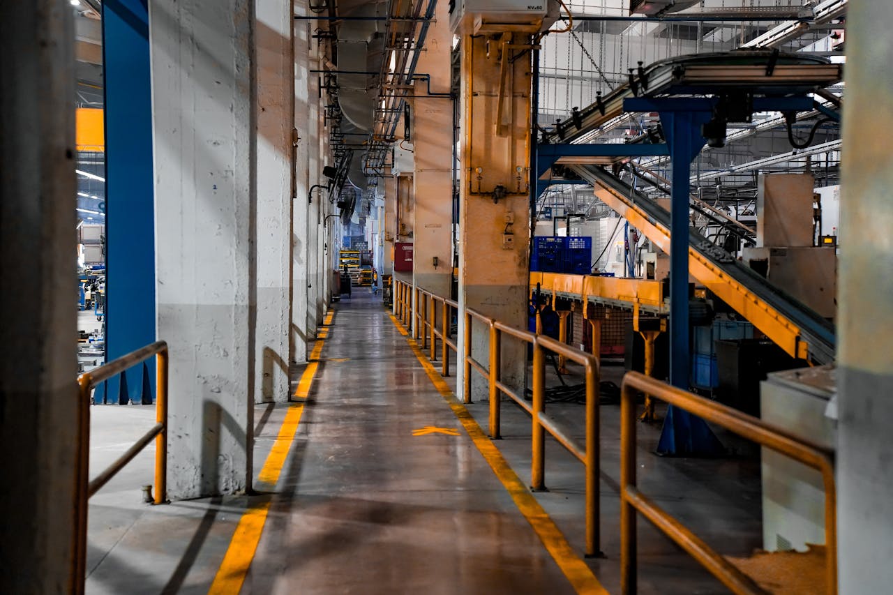 hero-contact Wide view of a modern factory interior showcasing industrial machinery and conveyor systems.